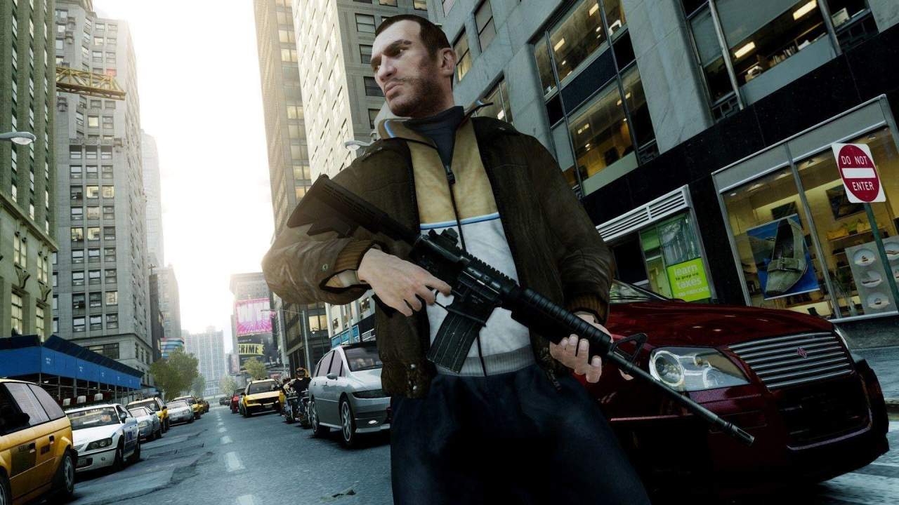 Grand Theft Auto IV Rockstar Classic Niko Bellic holding a rifle on a city street