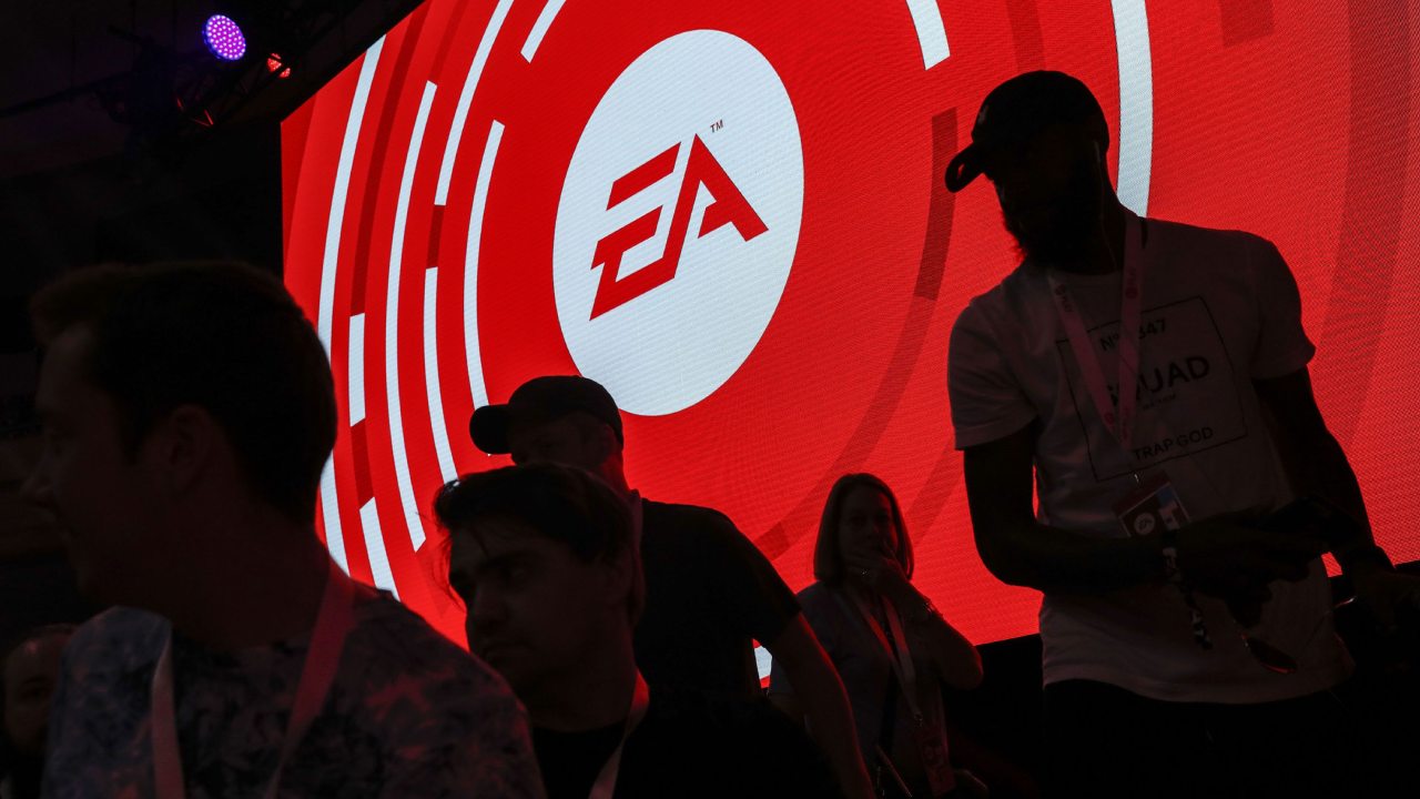 Electronic Arts attendees walking before logo
